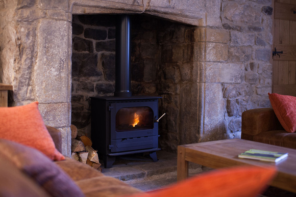 Dales Holiday property lounge, view of log burner in harth from comfy chairs.